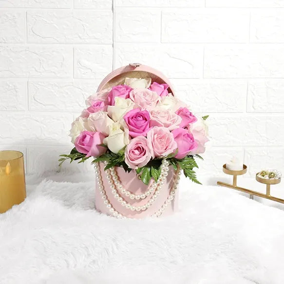 sweet white and pink roses in round box front view