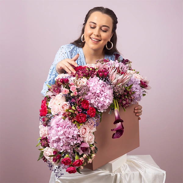 luxury box arrangement of carnation dark pink sweet avalanche roses front view