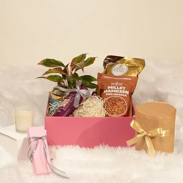gift hamper of aglaonema pink diamond plant with eat better snacks and Perfume front view 2