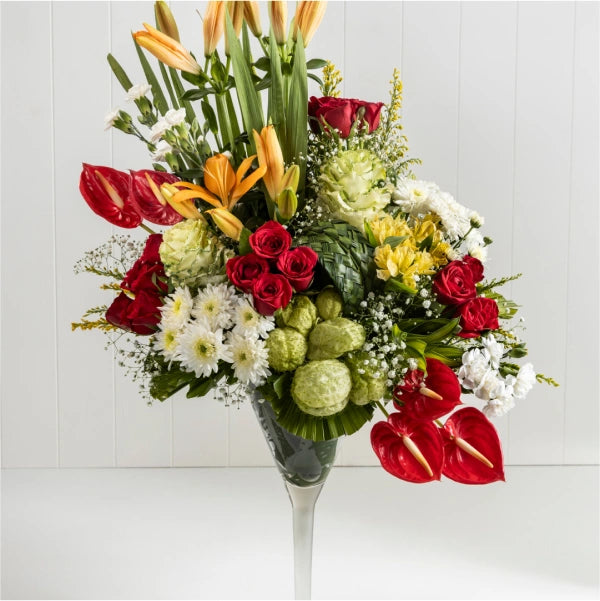 tropical bloom extravaganza in a whimsical wine glass vase closeup view