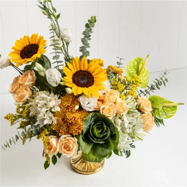 vase arrangement of peach rose sunflower orange chrysanthemum top view