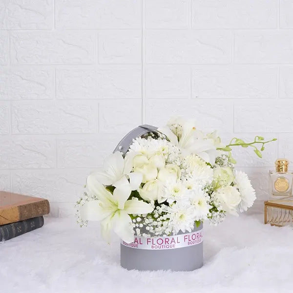 white roses asiatic lilies orchids in grey gift box front view